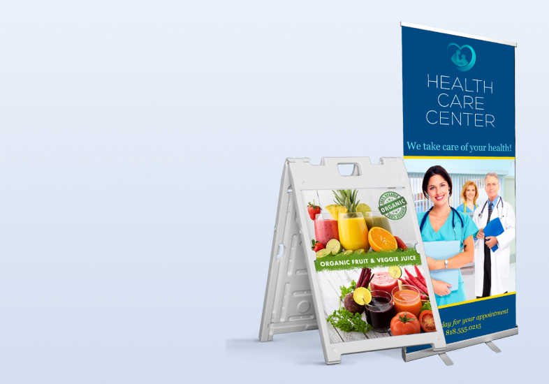 A health care center display features a colorful sign promoting organic fruit and veggie juices alongside a banner for appointments.